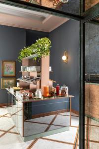 a table with a plant on it in a room at Hotel Marisa in Rome +76 photos