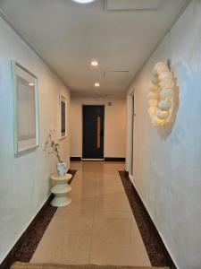a hallway with a toilet on the wall at The YoGwan in Suwon +26 photos