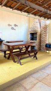 a ping pong table in a room with a fireplace at Casa em Praia de Flecheiras in Trairi