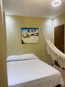 a bed with a hammock in a room at Casa em Praia de Flecheiras in Trairi