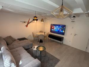 a living room with a couch and a table at 2-Zimmer Souterrain Wohnung in Kehl am Rhein