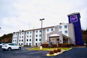 a hotel with a car parked in a parking lot at Sleep Inn Staunton in Staunton