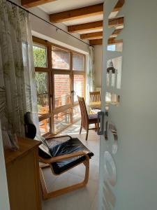 a room with a chair and a large window at Ferienhaus Uferweg in Otterndorf