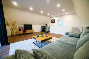 a living room with a couch and a tv at Kuća za odmor Aria in Krapina
