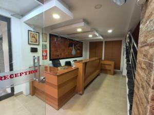 an office with a reception desk in a building at Hill View Residency in Kalpetta