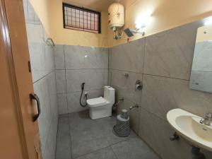 a bathroom with a toilet and a sink at Hill View Residency in Kalpetta +42 photos