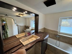 a bathroom with a wooden sink and a mirror at Tirol Stay in Ebbs +5 photos