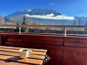 a cup of coffee sitting on a table on a balcony at Tirol Stay in Ebbs
