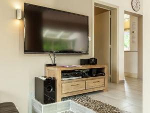 a large flat screen tv hanging on a wall at Luxury Villa with Sauna and bubble bath in Middelkerke