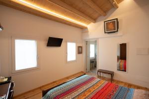 a bedroom with a bed and two windows at B&B Basta Bussare in Chioggia