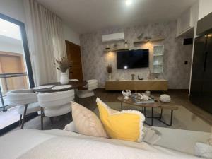 a living room with a bed and a dining room at Luxury Penthouse, Pool, Bbq, Private Terrace in Pueblo Bavaro