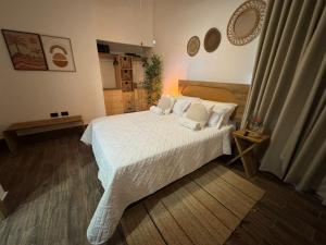 a bedroom with a bed with white sheets and pillows at Luxury Penthouse, Pool, Bbq, Private Terrace in Pueblo Bavaro +33 photos