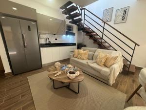 a living room with a couch and a table at Luxury Penthouse, Pool, Bbq, Private Terrace in Pueblo Bavaro