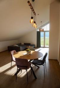 a living room with a table and chairs and a couch at Gipfelblick Weißenbacher in Übersee