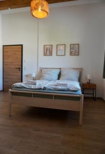 a large bed in a room with a lamp at Gipfelblick Weißenbacher in Übersee