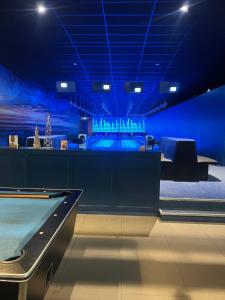 a room with a pool table and blue ceilings at BLUE BEACH HOUSE in Breskens