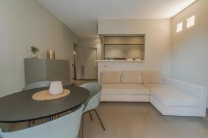 a living room with a table and a couch at Torrearsa street 35 in Trapani