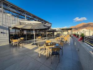 a restaurant with tables and chairs on a roof at Coral Beach Hotel & Spa in Aqaba