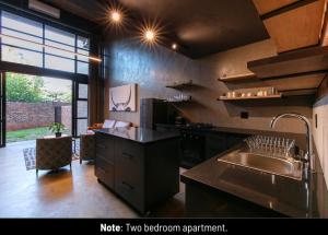 a kitchen with a sink and a counter top at Menlyn Lofts in Pretoria