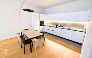 a kitchen and dining room with a table and chairs at HT - Basilica View Luxury Loft in Padova