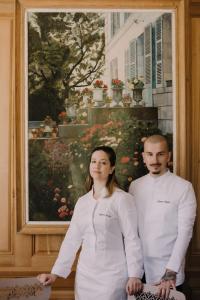 a man and a woman standing in front of a painting at Domaine Du Roncemay - Hôtel, Restaurants, Spa & Golf in Aillant-sur-Tholon +102 photos