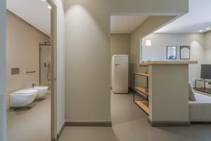 a bathroom with a white refrigerator and a sink at Torrearsa street 35 in Trapani +36 photos