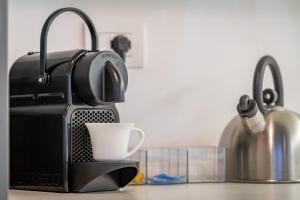 a coffee maker sitting on a counter with a cup at Gerusalemme's Nest - In the heart of the city in Milan