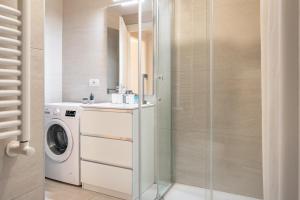 a bathroom with a washing machine and a washer at Gerusalemme's Nest - In the heart of the city in Milan +10 photos