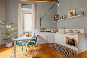 a kitchen with a table and chairs and a fireplace at Campo de Fiori Bright Apartment in Rome