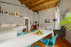 a kitchen and living room with a table and chairs at Campo de Fiori Bright Apartment in Rome