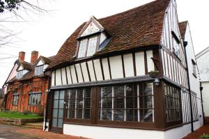a large white and brown building with windows at Chinnerys Country Cottage in Cavendish