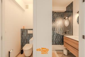 a bathroom with a toilet and a sink at Velasquez 0303 in Nieuwpoort