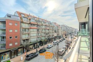 a view of a street with parked cars and buildings at Velasquez 0303 in Nieuwpoort