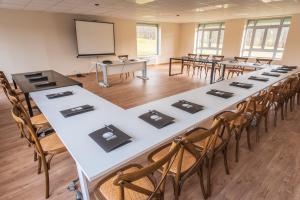 a large room with tables and chairs and a whiteboard at Golf Resort de Digne-les-Bains by Adonis in Digne-les-Bains +46 photos