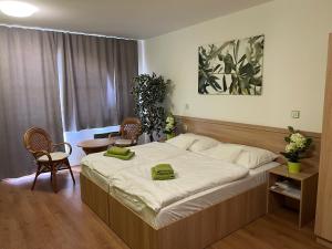 a bedroom with a large bed and a table and chairs at Opilý Sklep č3 in Velké Pavlovice