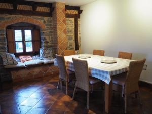 a dining room with a table and chairs and a couch at Arteondo in Mendeica