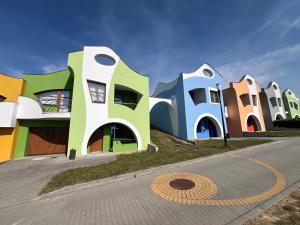 a row of colorful houses on the side of a road at Opilý Sklep č3 in Velké Pavlovice