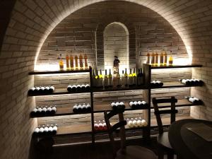 a room with a wall with bottles of wine at Opilý Sklep č3 in Velké Pavlovice