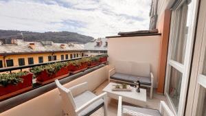 a balcony with chairs and a table and a window at Casa Elisabeth in Portovenere