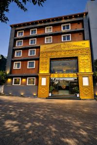 a building with a large yellow entrance to a building at Minta Hotel and Banquet in Noida