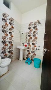a bathroom with a sink and a toilet and a sink at Hotel Orchha Inn in Orchha +12 photos