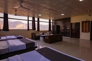 a large room with two beds and a living room at Flying Sparrow Riverside Resort in Dhikuli +93 photos