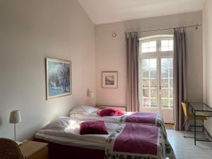 a bedroom with a bed and a window at Ravlunda Bränneri in Kivik