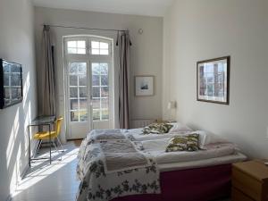 a bedroom with a bed and a window at Ravlunda Bränneri in Kivik