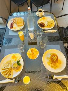 a table with plates of breakfast food on it at Sunway Ukulhas in Ukulhas