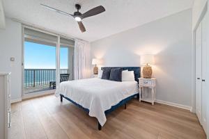 a bedroom with a bed with a view of the ocean at Beach Club D-801 in Gulf Highlands