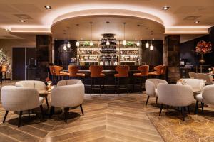 a restaurant with tables and chairs and a bar at Van der Valk Hotel Oostzaan - Amsterdam in Oostzaan