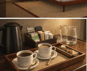 a table with two cups of coffee and a tray with glasses at The Scarlet Bath in Bath
