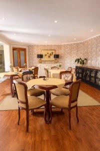 a dining room with tables and chairs and a fireplace at The Gables Boutique Hotel in Chintsa