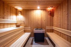 a sauna with wooden walls and a trash can in it at Hyatt Centric Reims in Reims